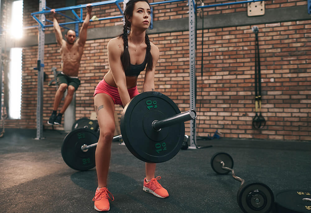 woman-preparing-to-lift-barbell-in-gym-U9ZCU47.jpg